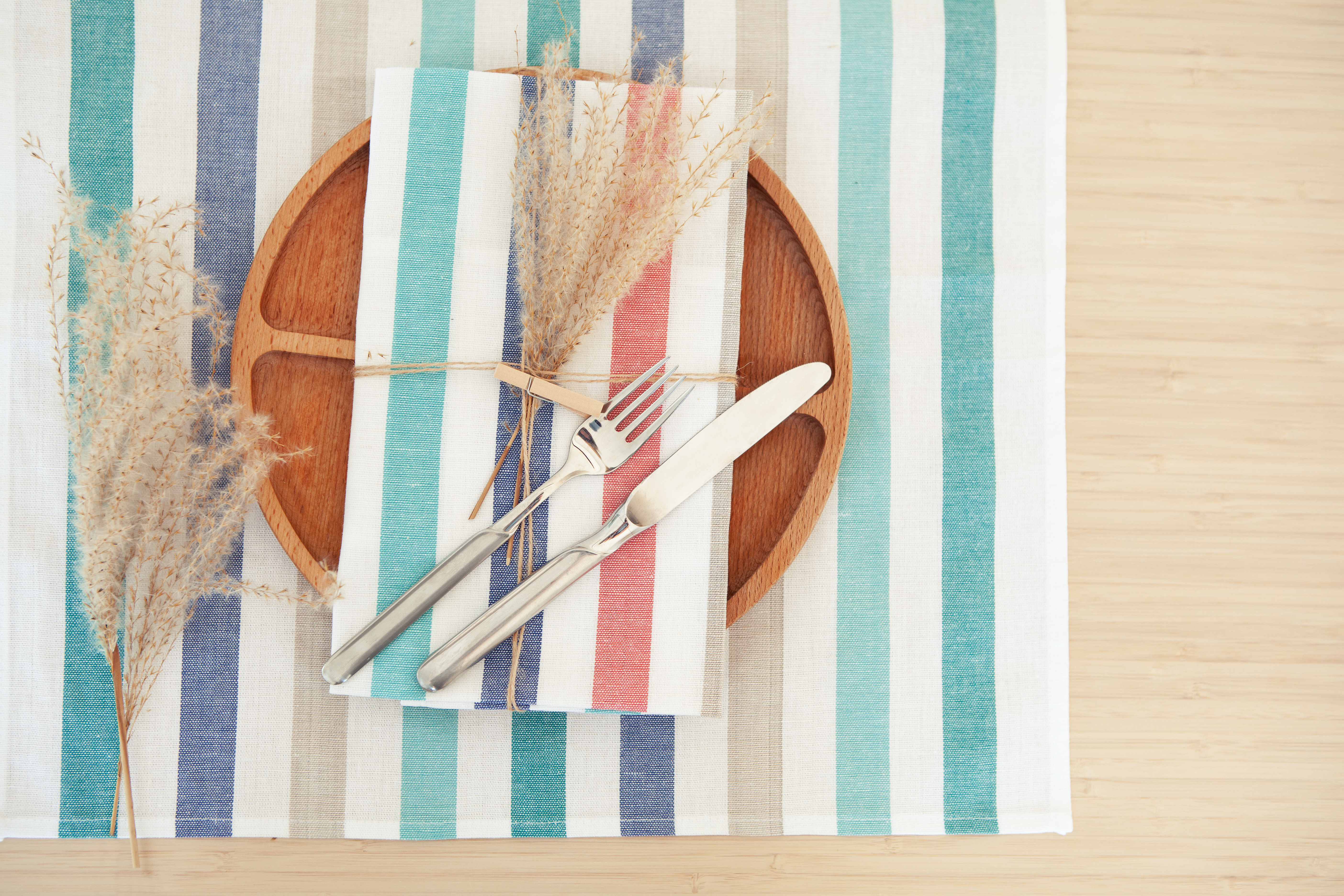 Natural Table Setting With Wood Plate and Striped Linens