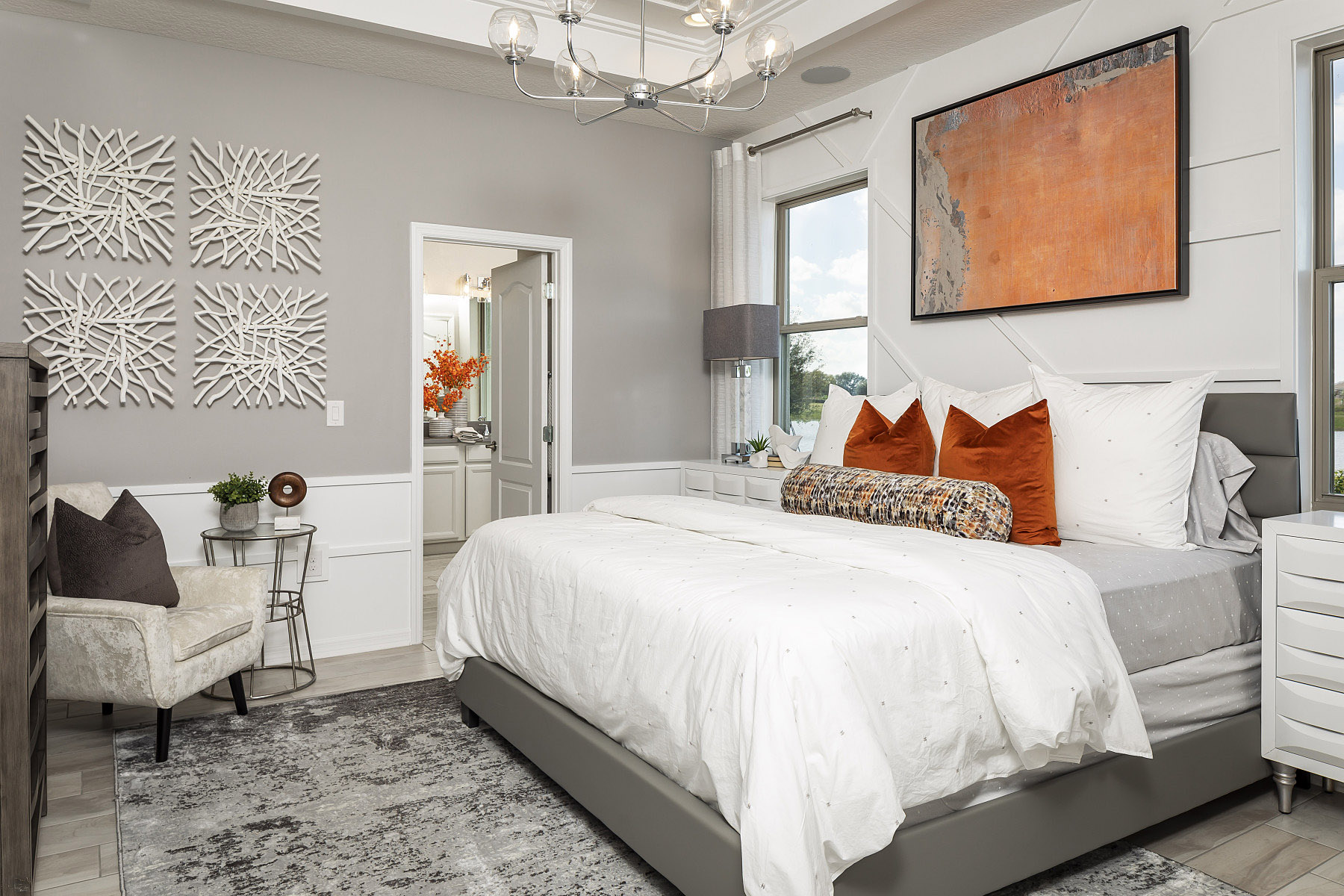Neutral Bedroom With Bright Orange Accent Colors