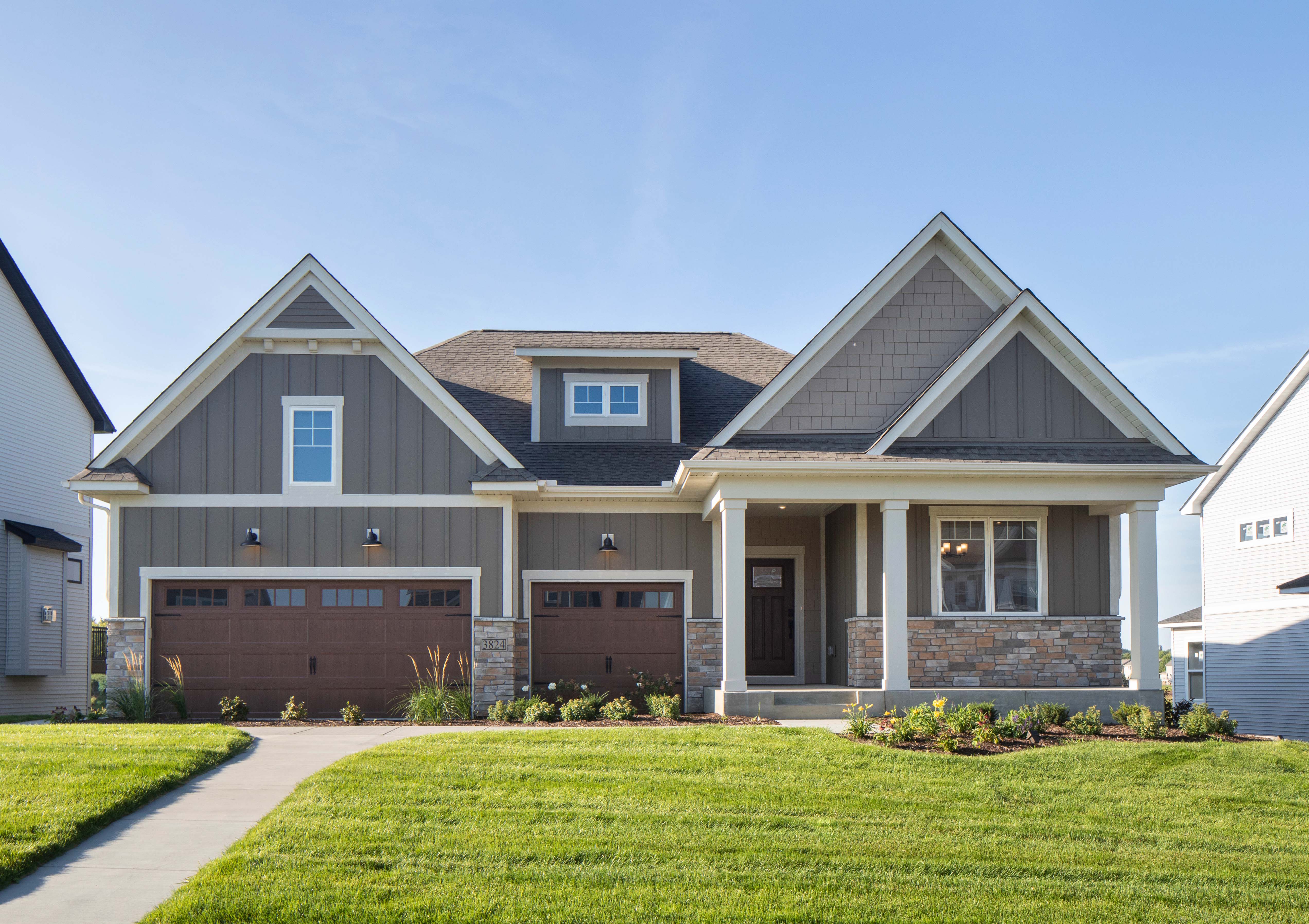 Front exterior of a craftsman style home with neutral tones