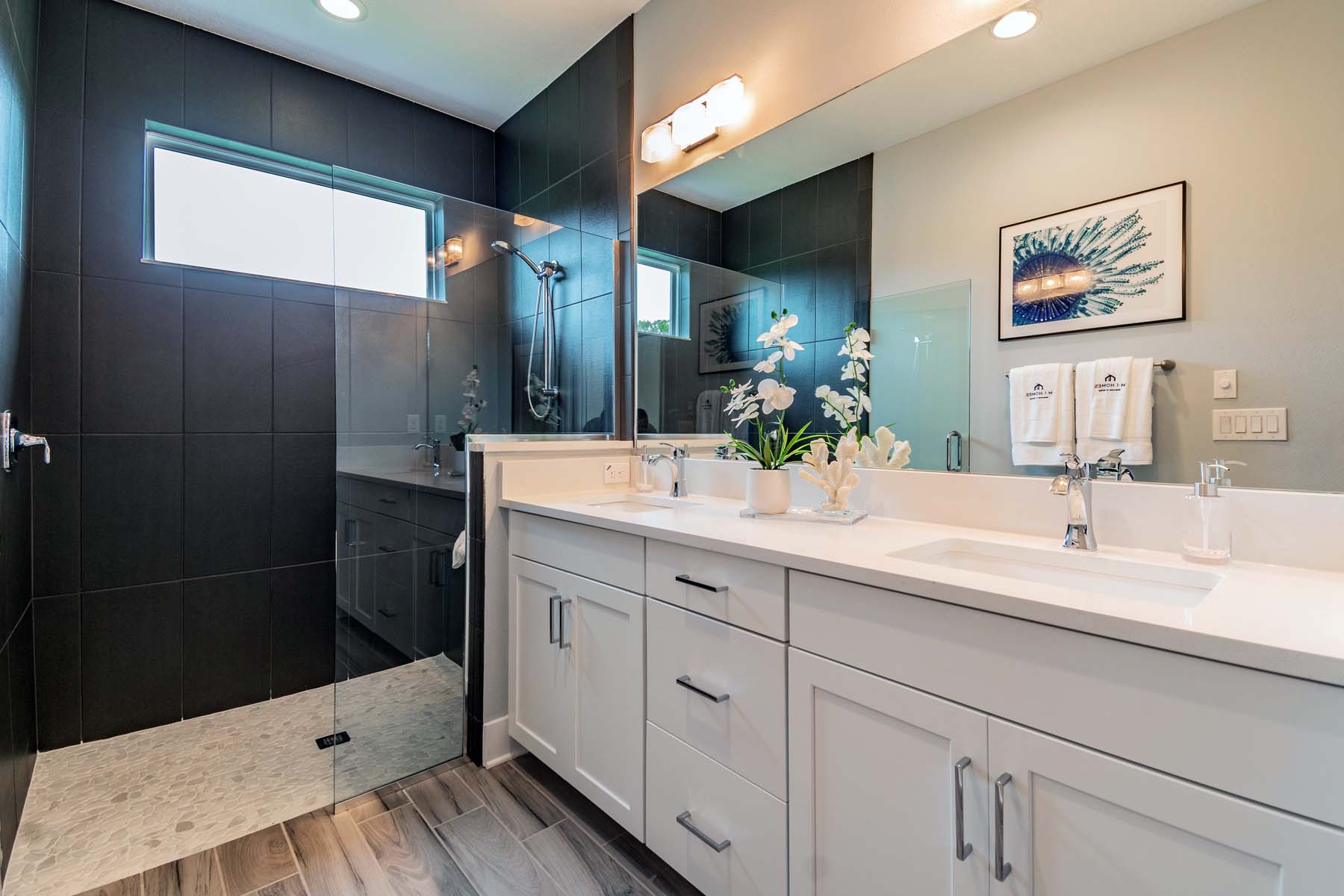 Owner's Bathroom With Dark Tile in Shower