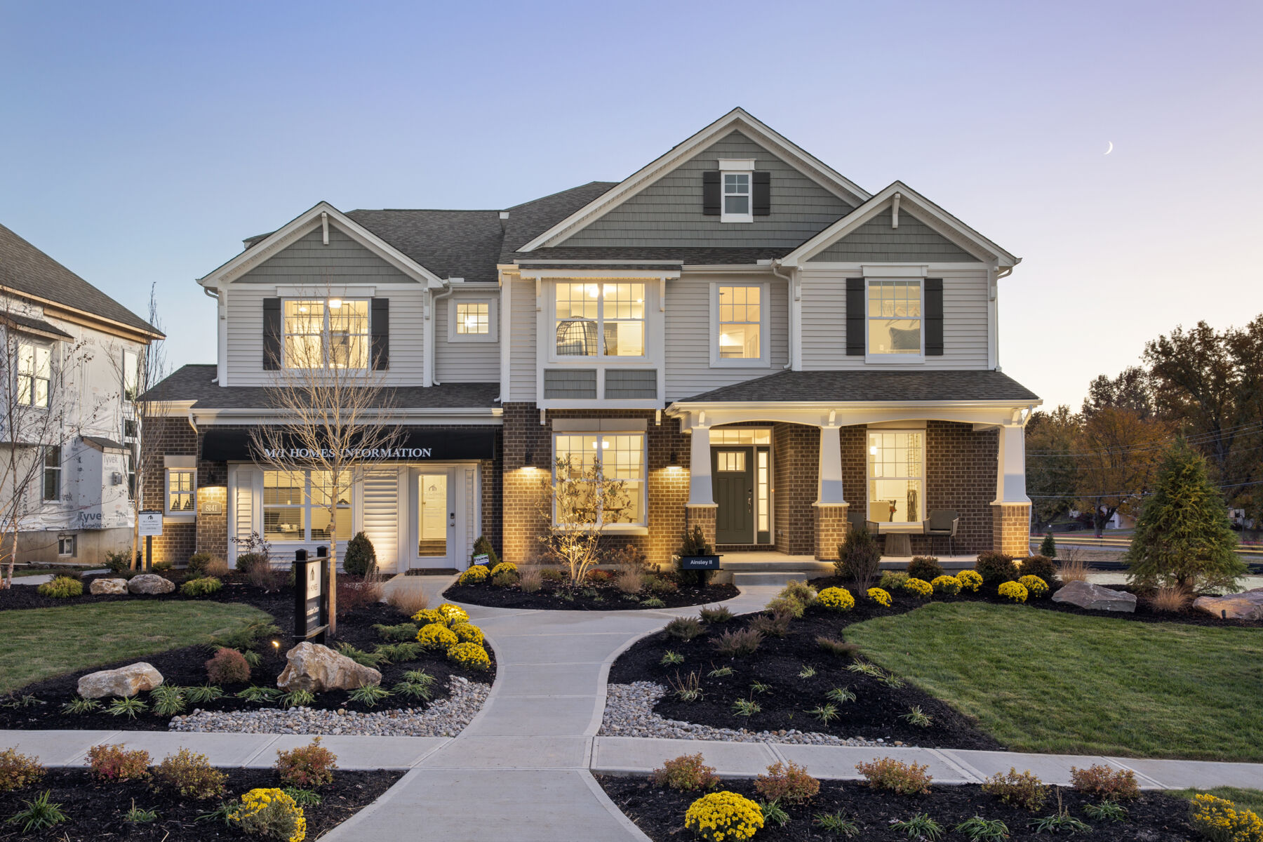 Front exterior of a model home at dusk