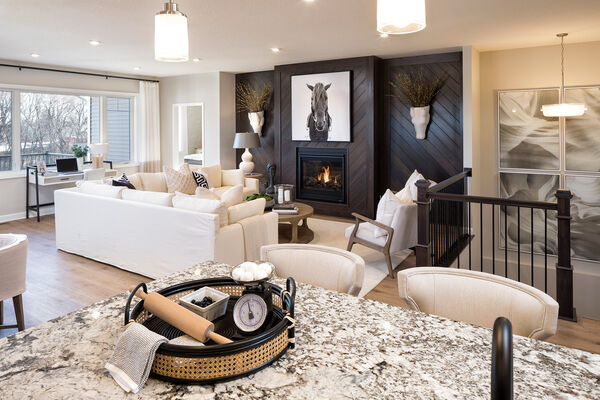 Family room with a fireplace inside a new construction home