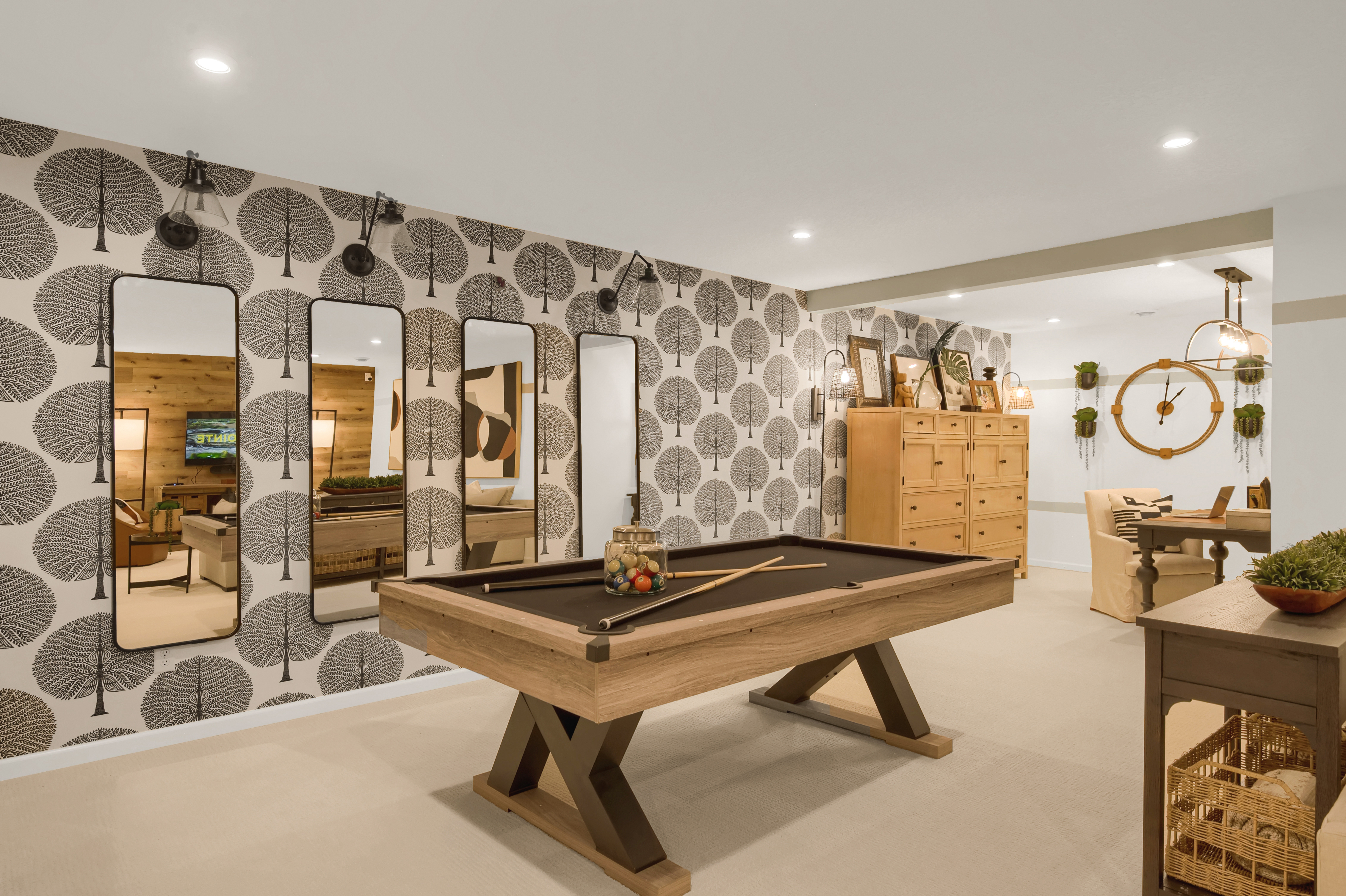 Basement With a Pool Table and Fun Wallpaper and Mirrors on Wall