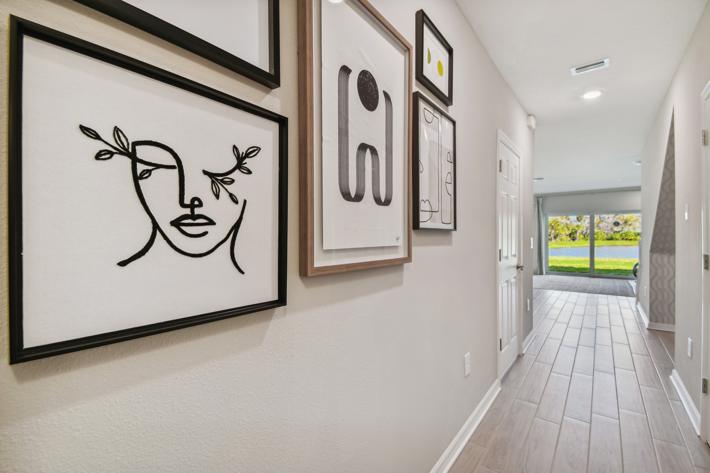 Hallway showcasing gallery wall with abstract art
