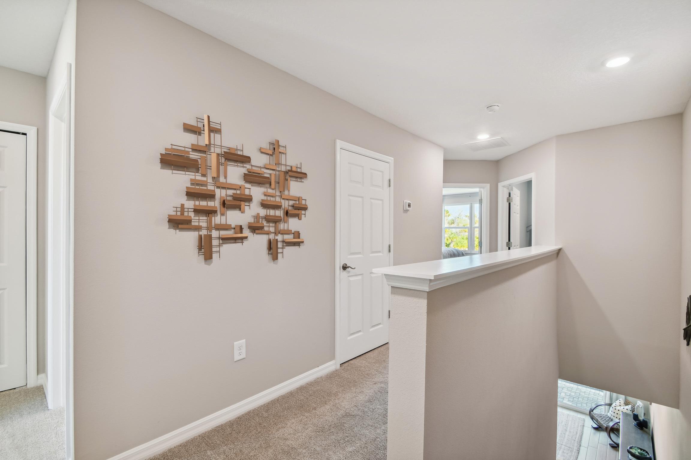 Small upstairs hallway with gold geometric wall art