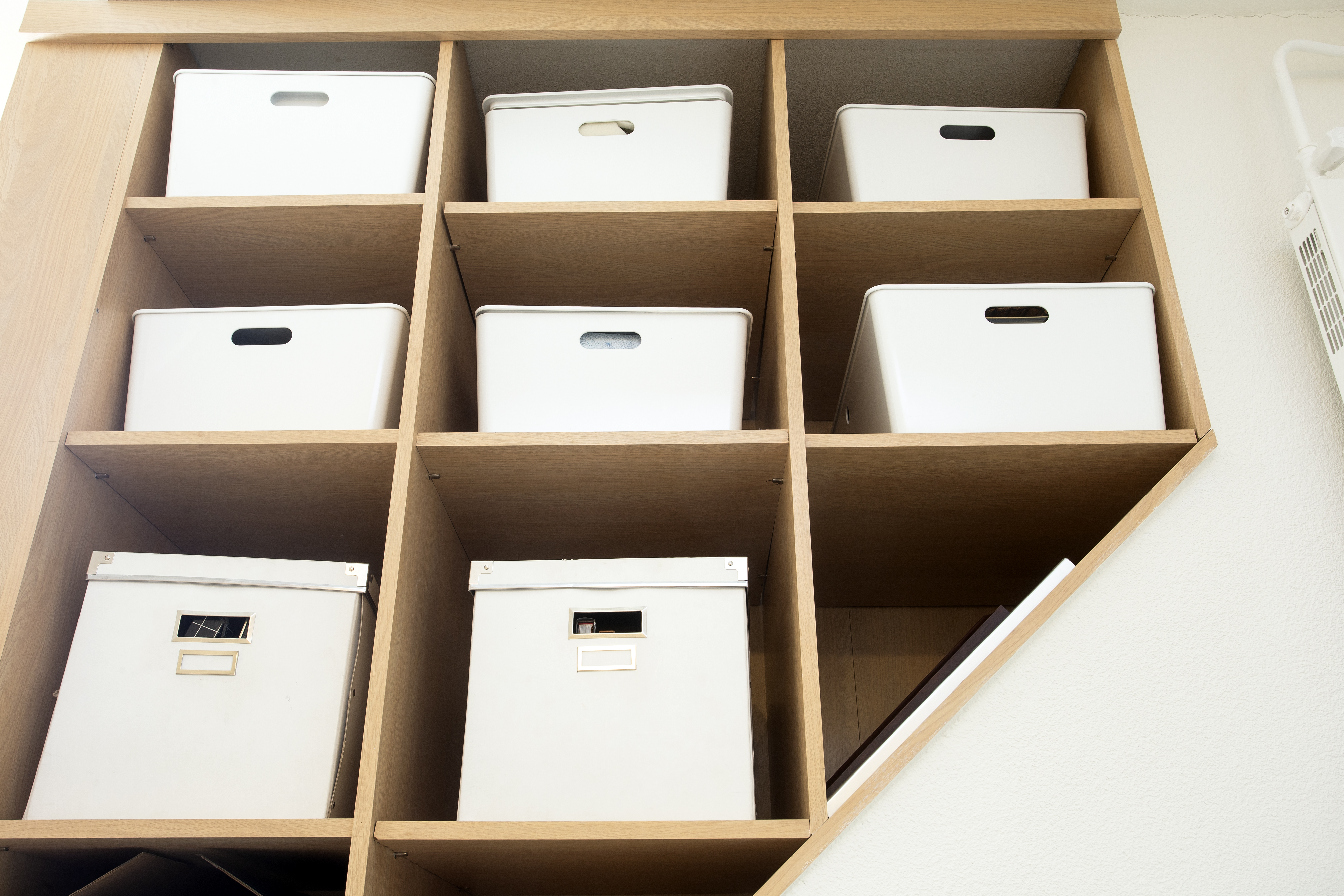 Wooden Shelving With Organized White Bins