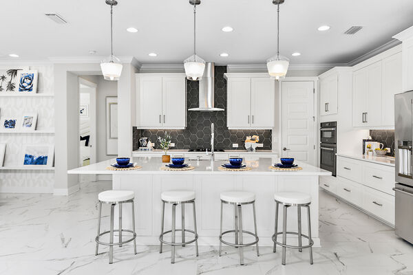 Image of a kitchen with white walls and countertops inside an M/I model home