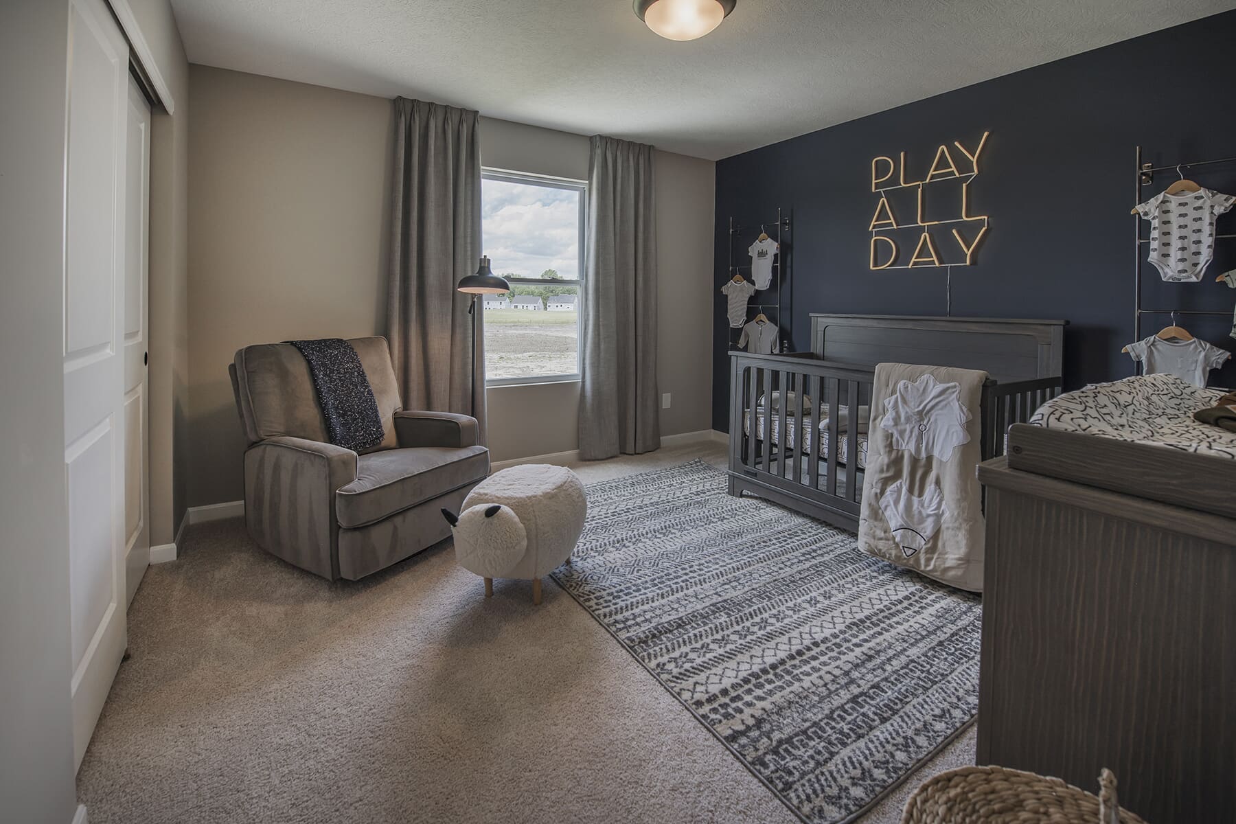 Nursery Room With Camper Room and Blue Wall