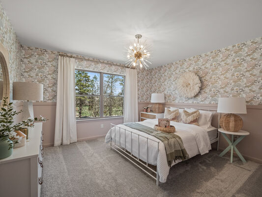 Image of a children's bedroom with pink floral wallpaper and a bed set